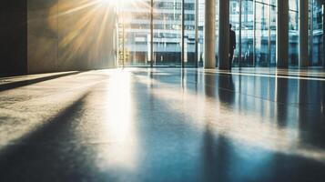A man is walking in a large, empty building with a lot of windows photo
