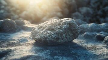 A large rock sits on a beach, surrounded by smaller rocks photo