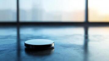 A coin is sitting on a table in front of a window photo