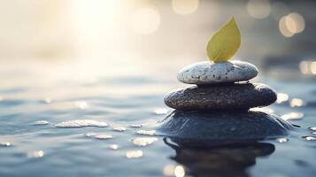 A rock is on top of another rock, and a leaf is on top of the rock photo