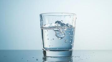 A glass of water with ice cubes in it photo