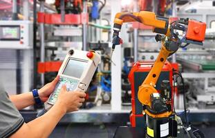 Engineer check and control automation Modern Robot system in factory, Industry Robot concept . photo