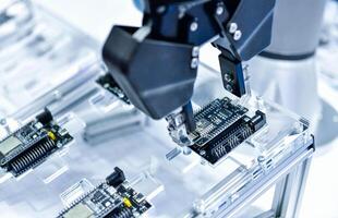 Modern Robot Arm automation system moving circuit boards in a factory ,industrial robot concept photo