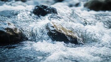 A rock is in the middle of a river with water splashing around it photo