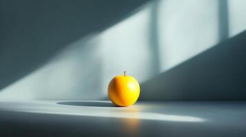 A single orange sits on a countertop in front of a window photo