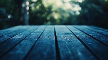 A blue wooden table with a view of trees in the background photo