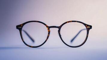 A pair of glasses with a brown frame and a brown lens photo