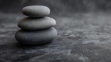Three large rocks are stacked on top of each other photo