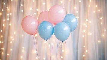Pastel pink and blue balloons with string lights and tulle backdrop. photo