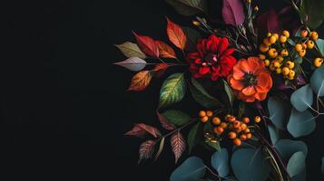 a close up of a bouquet of flowers on a black background with red, orange photo