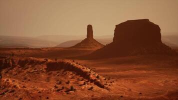 A majestic desert landscape with a prominent rock formation in the center video