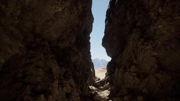 A narrow tunnel between two large rocks video
