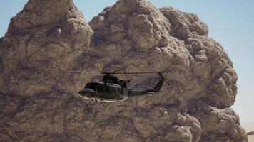 A helicopter flying over a mountain with a rock formation in the background video