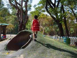 Cute girl playing in the playground during summer vacation. Happy children having fun in an outdoor park. photo
