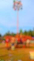 Abstract blurred background of a carnival ride with people. Funfair, festival, celebration concept. photo