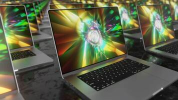 Lots of laptops with a bright colored screen saver moving on a dark background. 3d render. Seamless loop. video