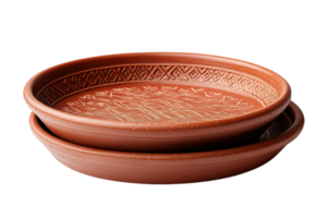 Decorative clay plates stacked together showcasing intricate patterns in an artisan workshop setting png