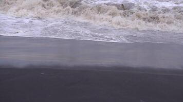 A person walking on the beach with a surfboard video