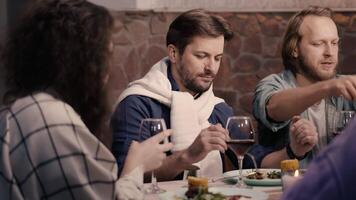 Friends enjoying dinner and wine together at restaurant video