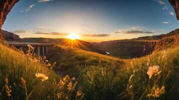 A scenic view of a canyon at sunset, framed by flowers and a bridge in the distance. photo