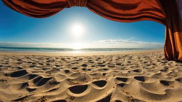 A serene beach view framed by draped fabric, highlighting the sun and tranquil waves. photo