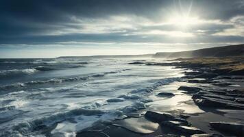 A dramatic coastal scene with waves, rocky shore, and a moody sky illuminated by sunlight. photo