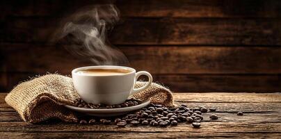 Coffee cup with steam and coffee beans on a wooden background. A cup of hot espresso or black latte, with a burlap sack on an old, rustic table photo