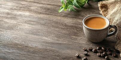 Coffee cup with steam and coffee beans on a wooden background. A cup of hot espresso or black latte, with a burlap sack on an old, rustic table photo