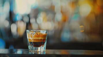 Espresso coffee pouring from an espresso machine in a bar, a closeup shot of a glass cup with a black or brown-colored crema on top of it. Blurred background of a modern cafe interior photo