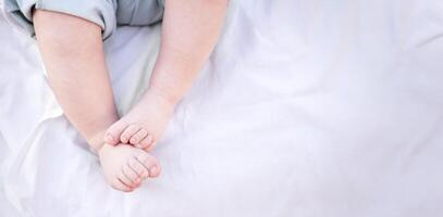 Legs close-up of newborn baby on light background photo