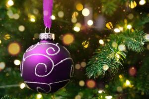 Christmas ornament on a fir branch with bokeh photo