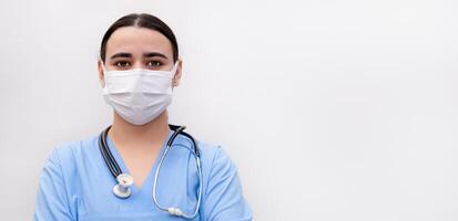 portrait of a nurse in a mask on a light background photo