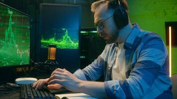 Exhausted Caucasian guy crypto trader broker man working overtime late night tiredness. Male worker yawn trading stock deadline at home neon freelancer typing computer software overwork programming photo