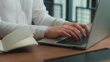 Hands typing computer laptop programming at workplace notebook planning business tasks unrecognizable woman female businesswoman student writing notes business girl at office desk working study learn photo