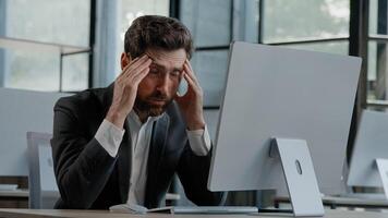 Tired Caucasian bearded 40s middle-aged businessman employee man typing laptop feel failure upset with lost of information online error stressed look at computer screen suffer from headache pressure photo