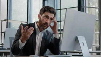 Caucasian 40s bearded boss investor entrepreneur employer man in office with computer working typing has problem with online project incorrect data in service lost connection bad result upset failure photo