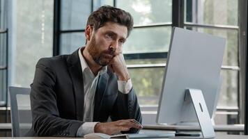 Tired lazy napping yawn adult bearded man male manager worker bored at work project online in computer in office Caucasian mature ill businessman need energy asleep feel overworked exhaustion syndrome photo