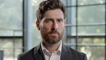 Business portrait in office serious calm middle-aged male boss employer adult Caucasian 40s bearded man looking at camera CEO leader trader male salesman manager worker businessman posing indoors photo