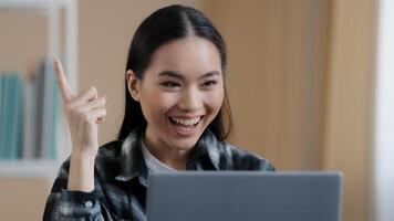 Thinking student girl asian pensive woman portrait sits in front of laptop doing online task looking for problem solution feels doubtful deep in thoughts makes decision comes up with idea find answer photo