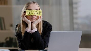 Tired sleepy funny lazy caucasian business woman with sticky notes on eyes glasses with stickers. Fatigued female worker napping at workplace sit at desk bored routine work pretends working sleeping photo