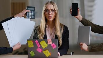 Multitasking business woman manager in office sitting at table have many tasks work feeling stress overworked exhausted from hands with calculator notebook papers phone tired girl in glasses headache photo