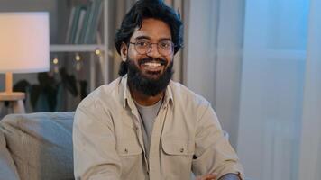 Arabic bearded surprised indian shocked man in glasses at home looking at camera says wow wide opens eyes and mouth in surprise of unexpected news happiness answers yes delight enthusiastic reaction photo