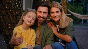 Close up happy smiling faces Caucasian family portrait outdoors in camping man father woman mother and child girl parents with custody adopted little small daughter looking at camera posing with smile photo