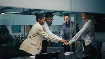 Multiracial business team group of workers developers managers looking at laptop in office celebrating success victory good news put palms up partnership unity gesture good investment financial profit photo