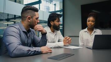 African American female businesswoman company CEO corporate mentor coach with laptop computer discuss startup corporate project with multiethnic business team diverse men brainstorm in office meeting photo