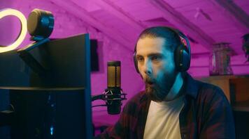 Shocked Caucasian man angry vlogger talking microphone mic addicted influencer scream furious blogger guy streaming losing game blog shout rage home e-sport vlog emotional male gamer gesturing photo