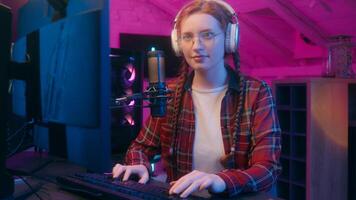 Close up Caucasian woman girl streamer gamer cyber gaming addiction female blogger influencer programmer coder look computer play game record radio podcast headphones online stream neon studio photo