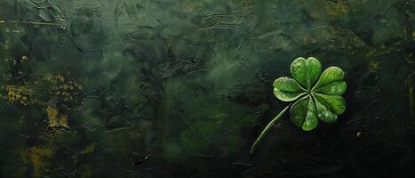 A beautiful four-leaf clover, a symbol of luck and good fortune, resting on a dark green background. photo