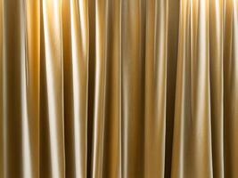Rich golden fabric drapes gracefully in soft light creating an elegant texture and depth that highlights its luxurious appeal photo