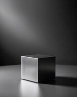 A black cube sitting on a table in front of a dark background photo